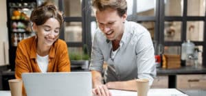 Man and woman working together on project sitting at desk