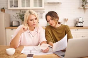 Women reviewing finances at home after refinancing his auto loan with Inspire Federal Credit Union in Bensalem, PA